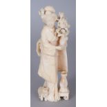 A GOOD QUALITY JAPANESE MEIJI PERIOD IVORY CARVING OF A STANDING LADY, bearing a spray of flowers, a