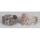 TWO 20TH CENTURY INDIAN SILVER-METAL FILIGREE BRACELETS, one inset with coral. (2)