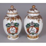 A PAIR OF SAMSON YONGZHENG STYLE FAMILLE ROSE ARMORIAL PORCELAIN TEA CADDIES & COVERS, 5in high