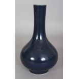 A CHINESE BLUE GLAZED PORCELAIN BOTTLE VASE, the base with a stylised seal mark, 8.3in high.