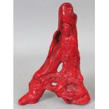 A GOOD 19TH/20TH CENTURY CHINESE PIECE OF CARVED RED CORAL, in the form of Guanyin supported by a