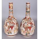 A PAIR OF EARLY 20TH CENTURY JAPANESE SATSUMA STYLE EARTHENWARE BOTTLE VASES, the sides moulded with