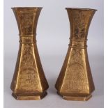 A PAIR OF EARLY/MID 20TH CENTURY ISLAMIC ENGRAVED BRASS VASES, of chamfered triangular section,