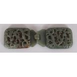A CHINESE GREEN JADE-LIKE PIERCED DRAGON BELT HOOK, in two sections, 5.75in wide when linked.