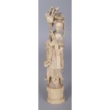 A JAPANESE MEIJI PERIOD IVORY OKIMONO OF A CHINESE FEMALE IMMORTAL, standing on a chamfered