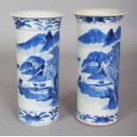 A PAIR OF 19TH CENTURY CHINESE BLUE & WHITE RIVER LANDSCAPE CYLINDRICAL PORCELAIN VASES, each base