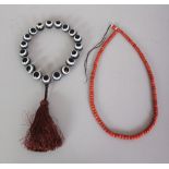 A CORAL NECKLACE, approx 24.5in long; together with a banded agate necklace, each spherical bead 0.