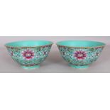 A PAIR OF CHINESE FAMILLE ROSE TURQUOISE GROUND LOTUS DECORATED PORCELAIN BOWLS, each base with a