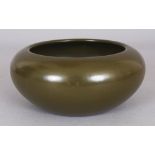 A CHINESE TEA DUST GLAZED SHALLOW PORCELAIN BOWL, the base with a Qianlong seal mark, 6.25in wide at