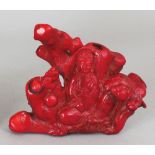 ANOTHER GOOD 19TH/20TH CENTURY CHINESE PIECE OF CARVED RED CORAL, in the form of Guanyin seated
