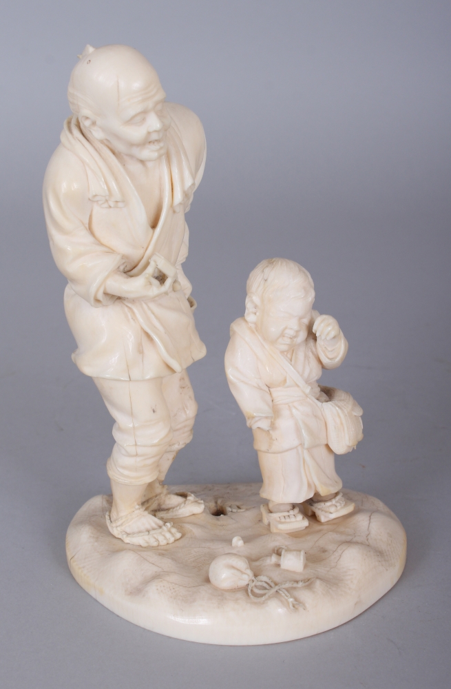 A FINE QUALITY JAPANESE MEIJI PERIOD IVORY OKIMONO OF A STANDING MAN IN THE COMPANY OF A CRYING BOY,