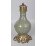 AN ORMOLU MOUNTED CHINESE MING STYLE LONGQUAN STYLE PORCELAIN VASE, fitted for electricity, the vase