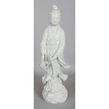 A FINE QUALITY CHINESE BLANC-DE-CHINE PORCELAIN FIGURE OF GUANYIN, standing on a wave plinth and