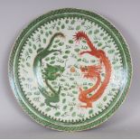 A 19TH/20TH CENTURY CHINESE CANTON GREEN & IRON-RED ENAMELLED PORCELAIN DRAGON CHARGER, 13.5in