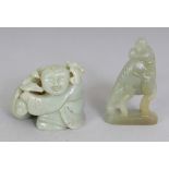 A CHINESE CELADON JADE MODEL OF A BOY, with a bag, lotus and a bat, 2.1in wide at widest point of