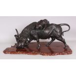 A LARGE SIGNED JAPANESE MEIJI PERIOD AKIMITSU BRONZE MODEL OF A BUFFALO BEING ATTACKED BY TWO