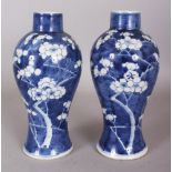 A PAIR OF 19TH CENTURY CHINESE BLUE & WHITE PORCELAIN PRUNUS VASES, each base with a four-