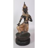 A 20TH CENTURY THAI GILT BRONZE OF A KNEELING THEPHANOM FIGURE, supported on a circular carved