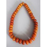 A LARGE AFRICAN AMBER STYLE NECKLACE, weighing 315gm, approx. 26in long.