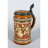 A GOOD METTLACH POTTERY TANKARD, etched with a band of revelling figures Pattern No: 2057 7in high