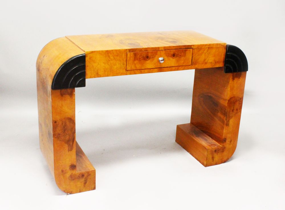 AN ART DECO STYLE BURR WOOD CONSOL TABLE, with a small drawer on curving end support 4ft 0in wide