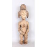 AN EARLY CARVED WOOD TRIBAL FIGURE with lime pigment. 23ins high.