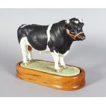 A ROYAL WORCESTER BRITISH FRIESIAN BULL, modelled by DORIS LINDNER 1964 No: 4438, on a wooden