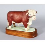 A ROYAL WORCESTER HEREFORD BULL, modelled by DORIS LINDER 1959, on a wooden base 6in long