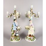 A GOOD PAIR OF LARGE CONTINENTAL DRESDEN DESIGN FOUR LIGHT CANDLE STICKS, each enameled with