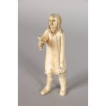 AN INUIT CARVED IVORY FIGURE. Outstretched figure holding a beaker 3.5ins.