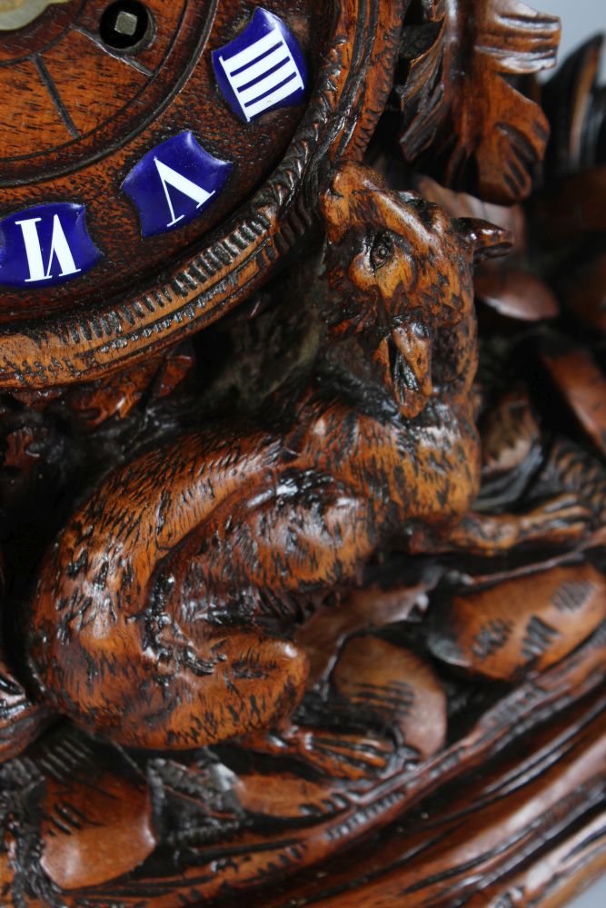 A GOOD 19TH CENTURY BLACK FOREST CARVED WOOD CLOCK, with blue and white Roman numerals, 8 day - Image 4 of 5