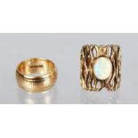 A 9ct GOLD WEDDING BAND AND A PIERCED GOLD RING, set with an opal