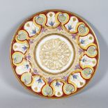 A SEVRES PORCELAIN CIRCULAR PLATE, the border with gold Anthemion motifs 9.5in diameter