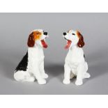 A PAIR OF ROYAL DOULTON PORCELAIN SEATED DOGS, yawning, HN1099 4ins high