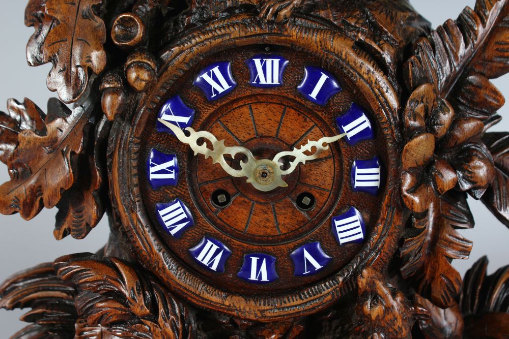 A GOOD 19TH CENTURY BLACK FOREST CARVED WOOD CLOCK, with blue and white Roman numerals, 8 day - Image 2 of 5