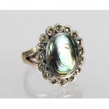 A large silver and mother-of-pearl ring.