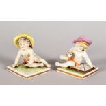 TWO MINIATURE CAPO DI MONTE PORCELAIN FIGURES OF YOUNG BOYS, on square bases 2.5in high