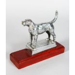 A FOX HOUND CAR MASCOT, 5in long on a wooden base