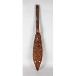 MAORI DANCE PADDLE Wood, paua shell, Slender form with cylindrical shaft and flat blade carved