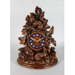 A GOOD 19TH CENTURY BLACK FOREST CARVED WOOD CLOCK, with blue and white Roman numerals, 8 day