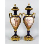 A SUPERB PAIR OF 19TH CENTURY SEVRES PORCELAIN AND GILDED ORMOLU TWO-HANDLED URN SHAPED VASES AND