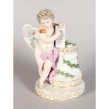 A GOOD 19TH CENTURY MEISSEN CUPID, standing beside a column with a table, on an oval base, Cross