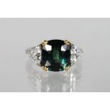 A SUPERB CUSHION SHAPED GREEN SAPPHIRE RING, 6.75cts, with diamond shoulders 1.4cts set in platinum