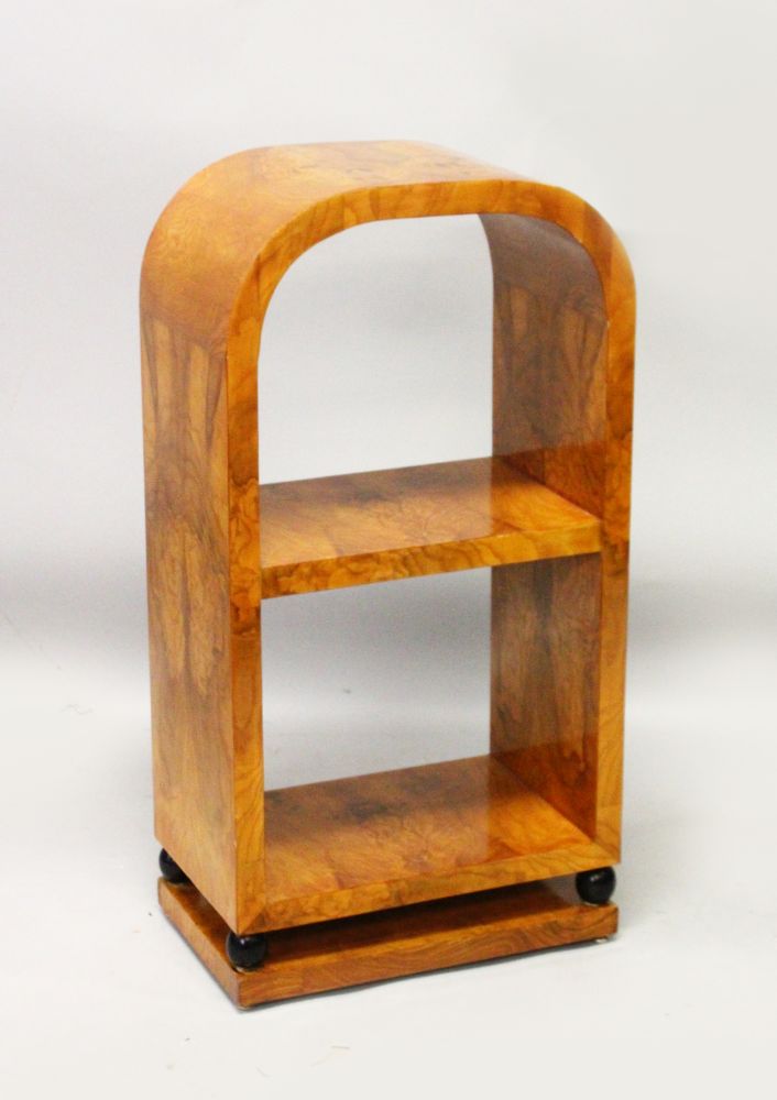 AN ART DECO STYLE BURR WOOD OPEN BOOKCASE. with curving top and a single shelf. 1ft 8in wide x 3ft