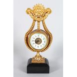 A SMALL GILDED LYRE CLOCK, on a marble base, 8.5in high
