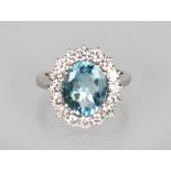 A GOOD OVAL AQUAMARINE AND DIAMOND CLUSTER RING, set in 18ct white gold