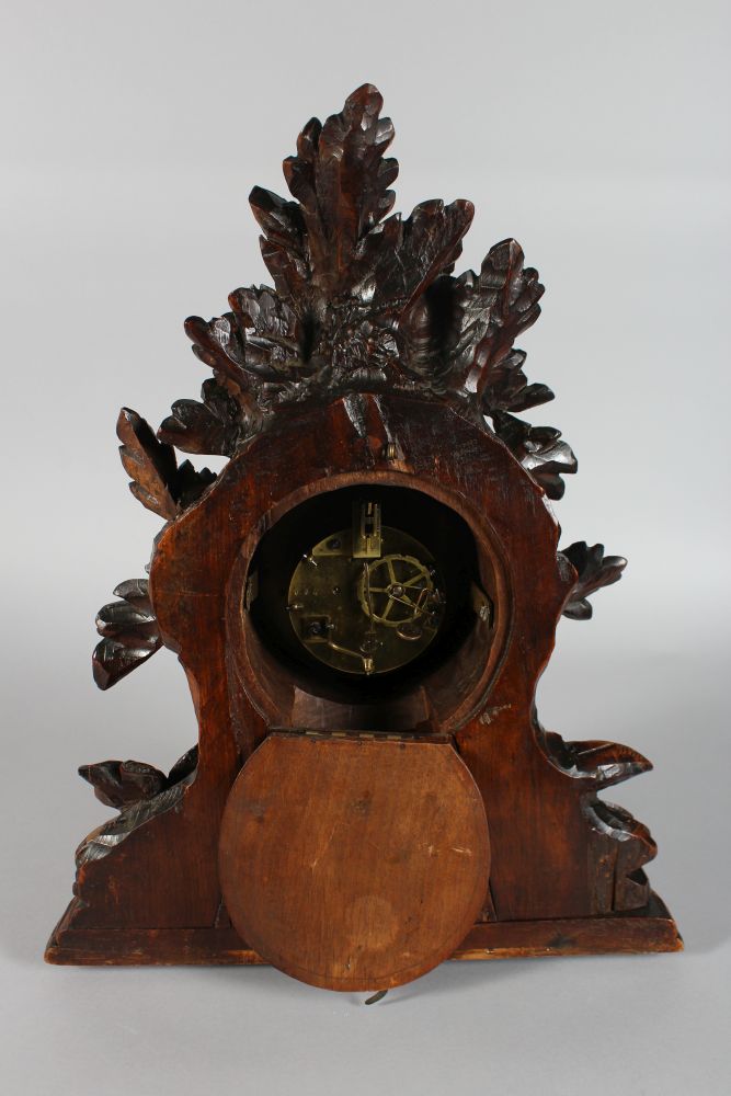 A GOOD 19TH CENTURY BLACK FOREST CARVED WOOD CLOCK, with blue and white Roman numerals, 8 day - Image 5 of 5