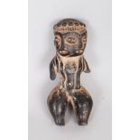 A SMALL SOUTH AMERICAN VOTIVE FIGURE with two faces. 4ins long.
