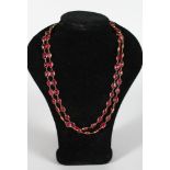 A LONG 18ct RUBY SET NECKLACE, set with 73 rubies, 38in long,