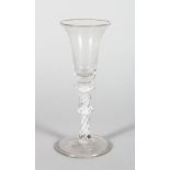 A GEORGIAN WINE GLASS, with inverted bell bowl and air twist knop stem 5.75in high